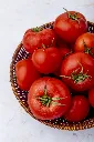 basket-whole-tomatoes-white-surface.webp